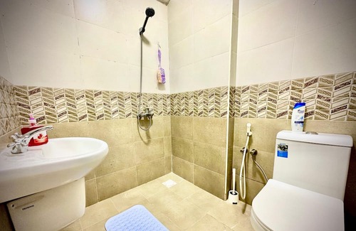 Seeb Apartment | Bedroom with an attached bathroom, shared kitchen in area with everything around