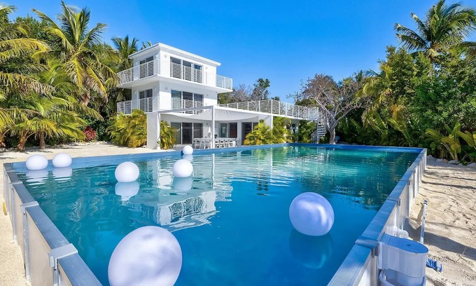 Rock Harbor Villa | Modern ocean side estate: 5 bed - 6 bath, big pool, 2 rooftops, small dock